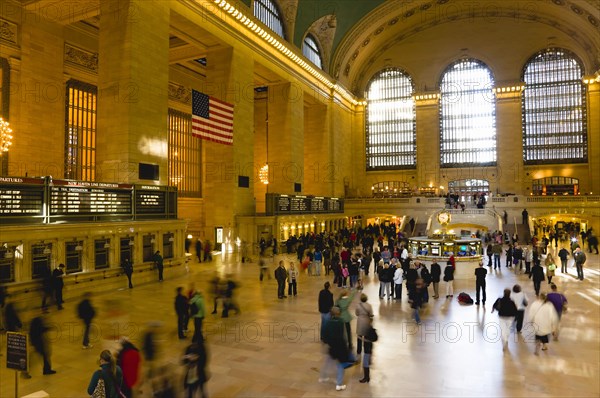 USA, New York, New York City, Manhattan  Grand Central Terminal railway station with people walking in the Main Concourse and passengers buying tickets.