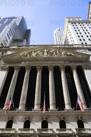 USA, New York, New York City, Manhattan  The New York Stock Exchange building in Broad Street beside Wall Street showing the main facade of the building featuring marble sculpture by John Quincy Adams Ward in the pediment called Integrity Protecting the W