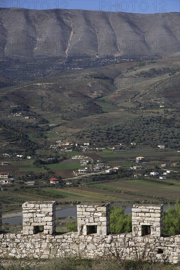 Albania, , Crenellated battlements of ancient castle with cannons with view across landscape beyond.