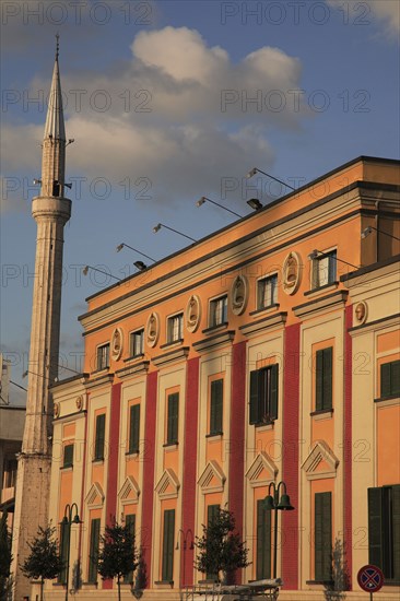Albania, Tirane, Tirana, Government building facades and minaret of Ethem Bey Mosque in Skanderbeg Sqaure.