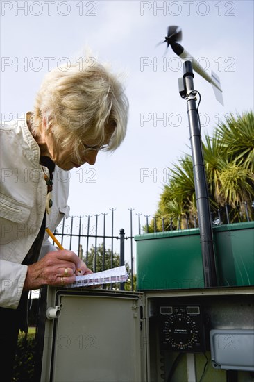 Climate, Weather, Measurements, Weather observer taking readings from the wind speed direction monitor at Bognor Regis weather station.