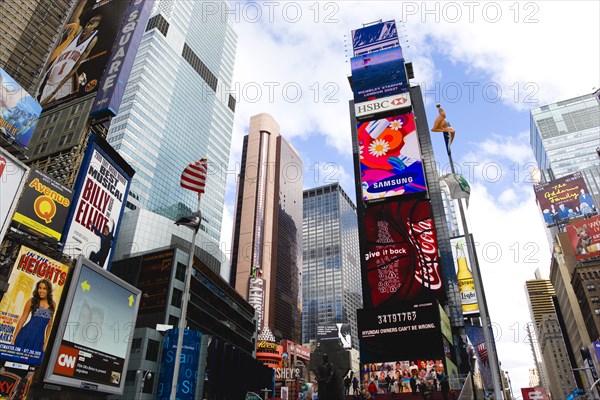 USA, New York, New York City, Manhattan  Times Square at the junction of 7th Avenue and Broadway below buildings with advertising on large video screens.