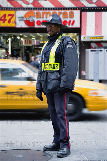 USA, New York, New York City, Manhattan  Times Square Public Safety Officer in uniform on patrol in the major midtown tourist destination.