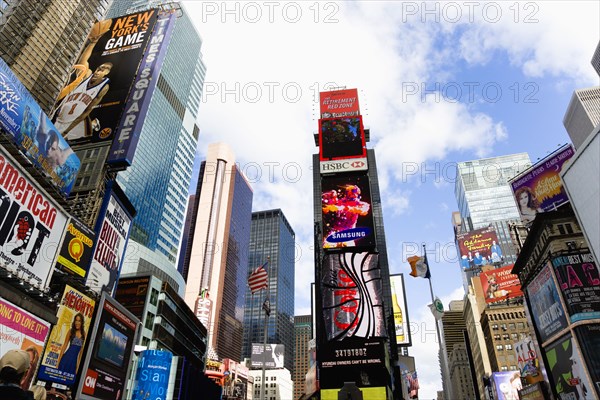 USA, New York, New York City, Manhattan  Skyscrapers in Times Square at the junction of 7th Avenue and Broadway below buildings with advertising on large video screens.