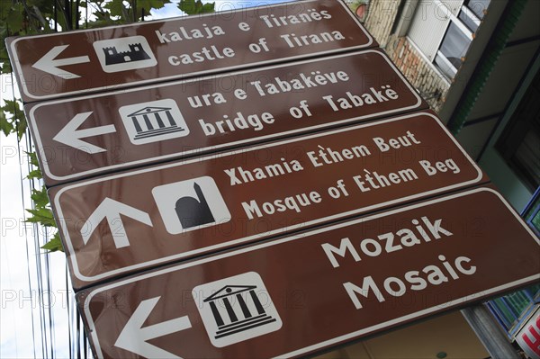 Albania, Tirane, Tirana, Street sign giving directions for places of interest in the city.