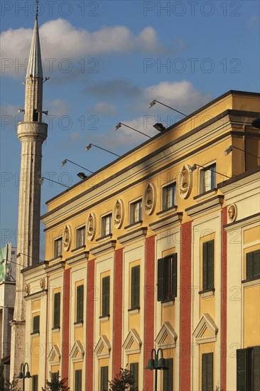 Albania, Tirane, Tirana, Part view of exterior facade of government buildings and minaret of Ethem Bey Mosque on Skanderbeg Square.