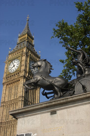 England, London, Westminster, Angled view looking up at Big Ben clock tower with the Boadicea statue in the foreground