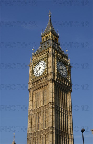 England, London, Westminster, Angled view looking up at Big Ben clock tower against a blue sky