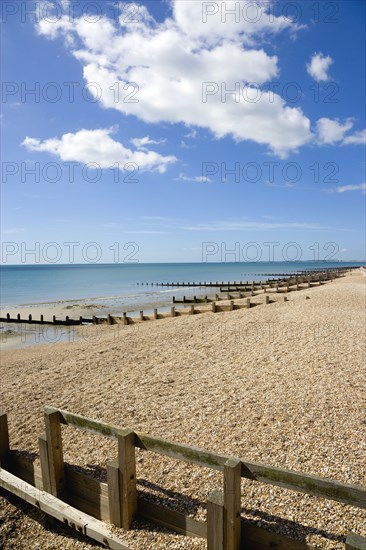 England, West Sussex, Bognor Regis, Wooden groynes at low tide used as sea defences against erosion of the shingle pebble beach.