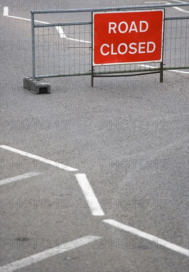 Transport, Road, Signs, Red Road Closed Traffic sign on barrier across empty urban road.