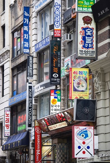 USA, New York, New York City, Manhattan  Korean signs for restaurants and shops on buildings in Little Korea on West 32nd Street in midtown.