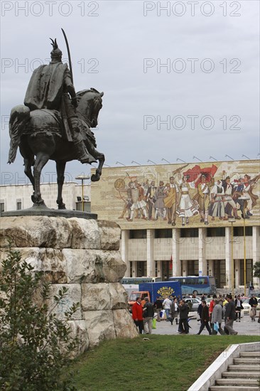 Albania, Tirane, Tirana, Equestrian statue of George Castriot Skanderbeg in busy Skanderbeg Square with the National History Museum exterior facade and mural beyond.