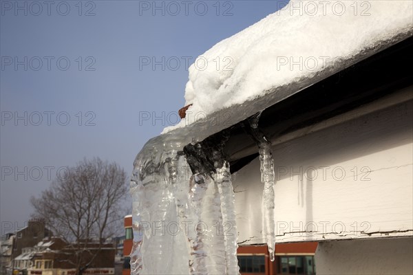 Weather, Winter, Ice, Large Icicle hanging from roof gutters.