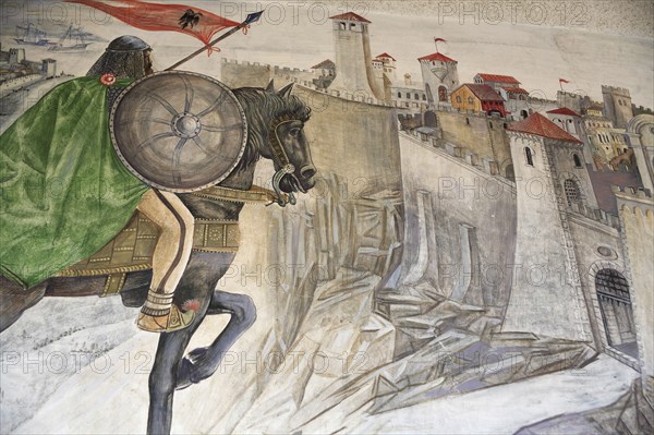 Albania, Kruja, Mural on the wall of the National Skanderbeg Museum depicting battle scene.