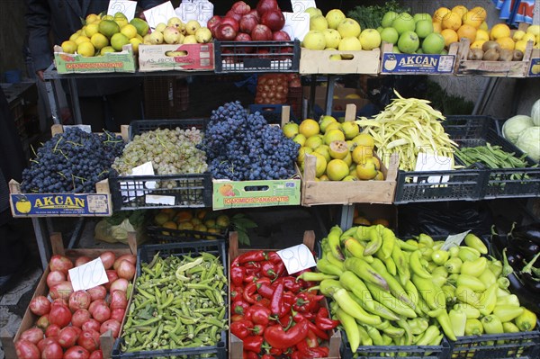 Albania, Tirane, Tirana, Display of fruit and vegetables including grapes  apples  okra and peppers in a grocer shop in the Avni Rustemi market.