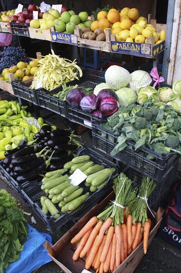 Albania, Tirane, Tirana, Display of fruit and vegetables including aubergines  carrots and cabbage at grocers in the Avni Rustemi market.