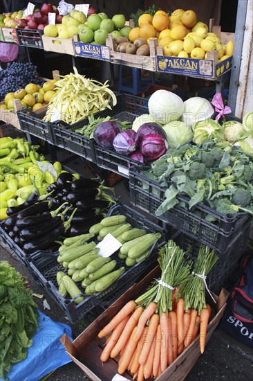 Albania, Tirane, Tirana, Display of fruit and vegetables including carrots  aubergine and cabbage at grocers shop in the Avni Rustemi market.