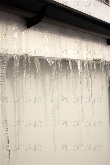 Weather, Winter, Ice, Large Icicles hanging from roof eaves.