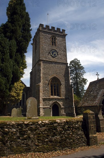 England, Devon, General, Church clock tower and entrance seen from graveyard