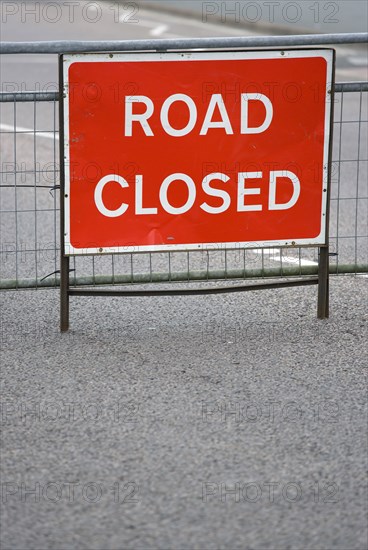 Transport, Road, Signs, Red Road Closed Traffic sign on barrier across empty urban road.