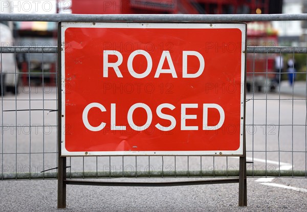 Transport, Road, Signs, Red Road Closed traffic sign on barrier across empty urban road.