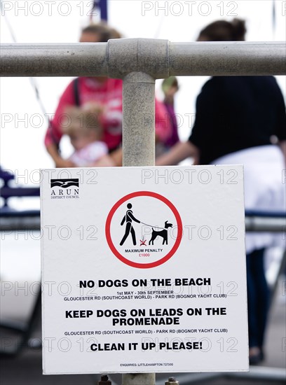 England, West Sussex, Bognor Regis, Sign on seafront railings warning that no dogs are allowed on the beach  must wear leads on the promenade and must be cleaned up afterwards.