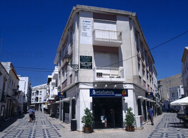 Portugal, Algarve, Faro, Main shopping area with white washed buildings and colourfully decorated pavement