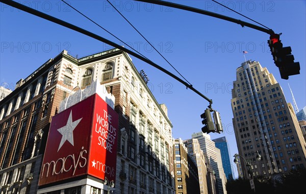 USA, New York, New York City, Manhattan  Macys department store with cars on 34th Street and Broadway with overhead traffic control lights.