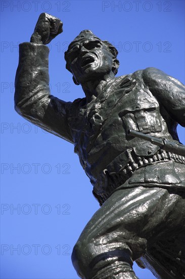 Albania, Tirane, Tirana, Statue of the Unknown Partisan. Part view from below  looking upwards  against blue sky.
