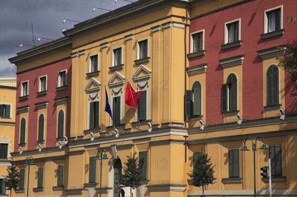 Albania, Tirane, Tirana, Pink and yellow exterior facades of government buildings on Skanderbeg Square.