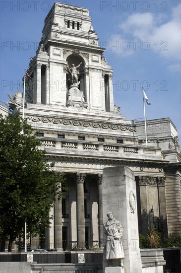 England, London, Memorial statue of a soldier with architecture behind