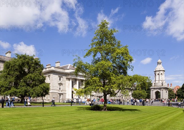 Ireland, County Dublin, Dublin City, Trinity College university with people walking through Parliament Square towards the Campanile.