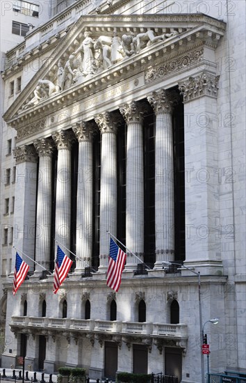 USA, New York, New York City, Manhattan  The New York Stock Exchange building in Broad Street beside Wall Street showing the main facade of the building featuring marble sculpture by John Quincy Adams Ward in the pediment called Integrity Protecting the W