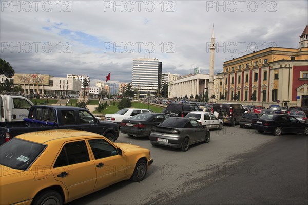 Albania, Tirane, Tirana, Congested traffic on Skanderbeg Square. Buildings include Ethem Bey Mosque  the Opera House and National History Museum.