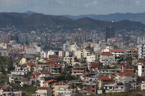 Albania, Tirane, Tirana, View across residential buildings to the hillside beyond.