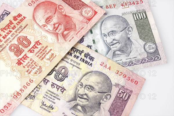 Business, Finance, Money, Indian bank notes featuring Mahatma Gandhi in twenty  fifty and one hundred rupee denominations.