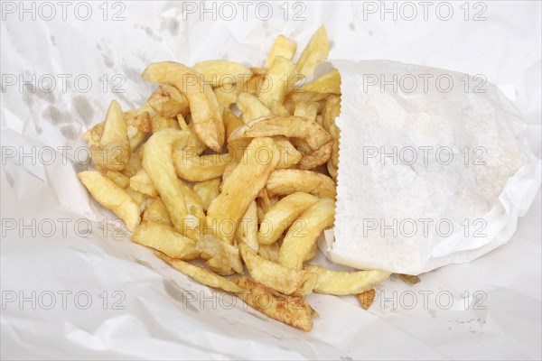Food, Fast Food, Fish and Chips, Deep fried potato chips bought from Fish and Chip Shop  still in their paper wrapping.