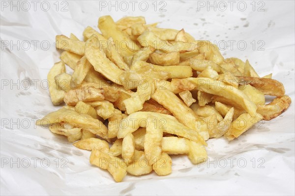 Food, Fast Food, Fish and Chips, Portion of deep fried chips from Fish and Chip shop  still in their paper wrapping.