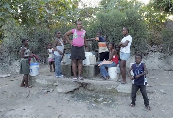Haiti, La Gonave, Children using water pump provided by the Scottish Charity LemonAid clean water program.