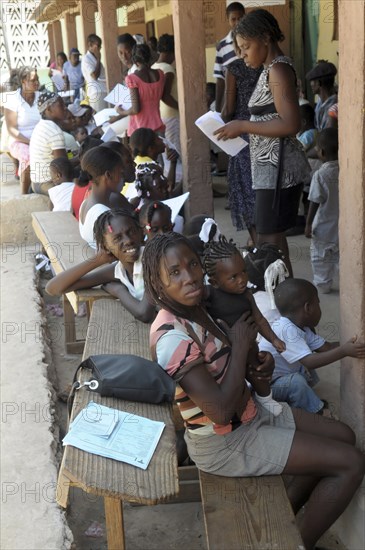 Haiti, La Gonave, Mothers with babies waiting to be vaccinated by the Scottish Charity LemonAid who help support the people with health care  clean water programs and giving goats to families