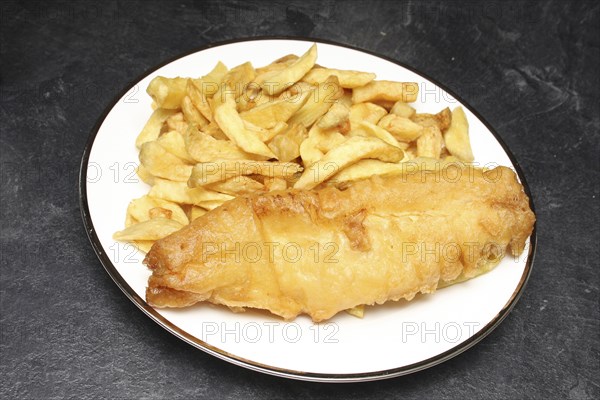 Food, Fast Food, Fish and Chips, Portion of deep fried chips and battered cod from Fish and Chip shop on plate.