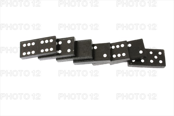 Games, Dominoes, Domino pieces fallen against each other on a white background.