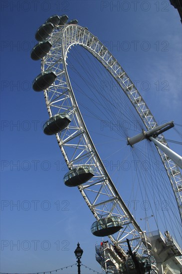 England, London, British Airways London Eye seen from below against a blue sky