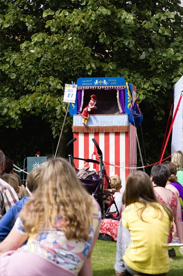 Children, Entertainment, Punch And Judy, Children sitting on grass watching the traditional puppet show.