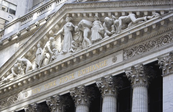 USA, New York, New York City, Manhattan  The New York Stock Exchange building in Broad Street beside Wall Street showing the main facade of the building featuring marble sculpture by John Quincy Adams Ward in the pediment called Integrity Protecting the W