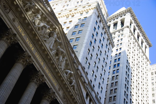 USA, New York, New York City, Manhattan  The New York Stock Exchange building in Broad Street beside Wall Street showing the main facade of the building featuring marble sculpture by John Quincy Adams Ward in the pediment called Integrity Protecting the W