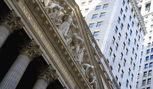 USA, New York, New York City, Manhattan  The New York Stock Exchange building in Broad Street beside Wall Street showing the main facade of the building featuring marble sculpture by John Quincy Adams Ward in the pediment called Integrity Protecting the W