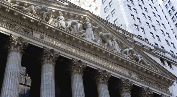 USA, New York, New York City, Manhattan  The New York Stock Exchange building in Broad Street beside Wall Street showing the main facade of the building featuring marble sculpture by John Quincy Adams Ward in the pediment called Integrity Protecting the W