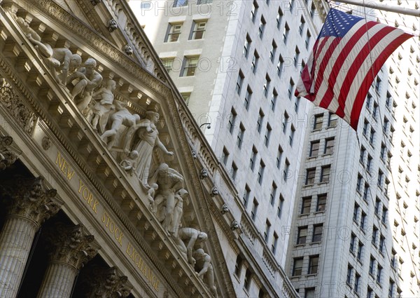 USA, New York, New York City, Manhattan  The New York Stock Exchange building in Broad Street beside Wall Street showing the main facade of the building featuring marble sculpture by John Quincy Adams Ward in the pediment called Integrity Protecting the W