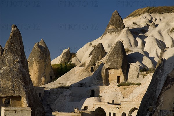 Peaked rooftops of cave dwellings set into volcanic tufa of hillside. Photo : Hugh Rooney